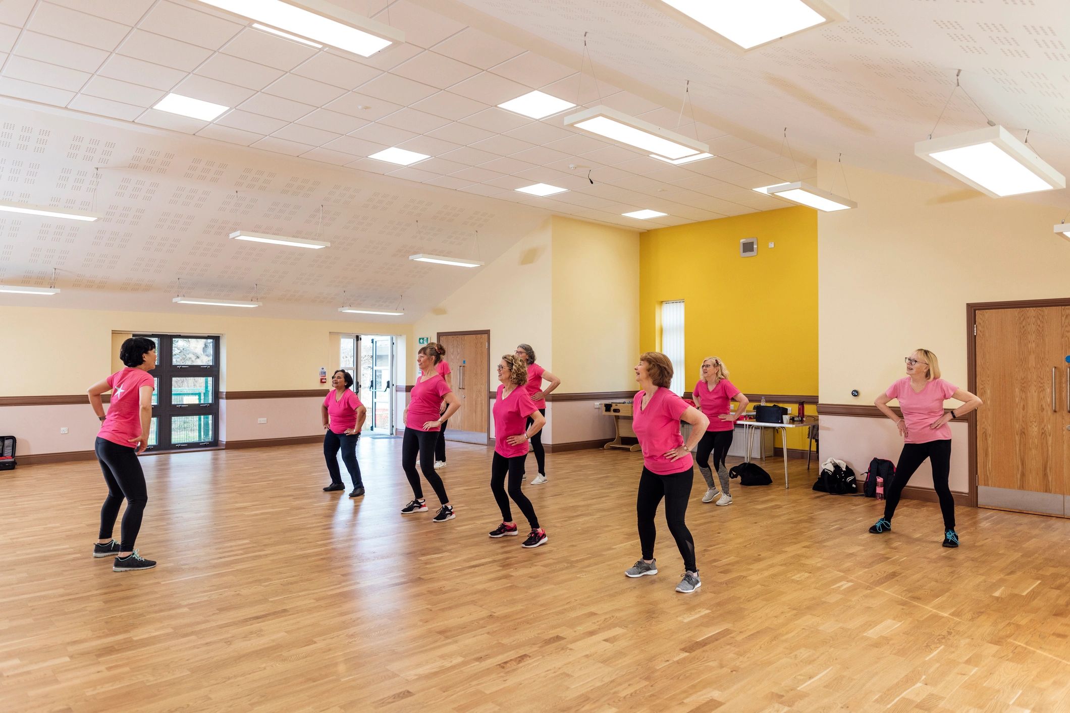 Adults enjoying an upbeat dance fitness class together