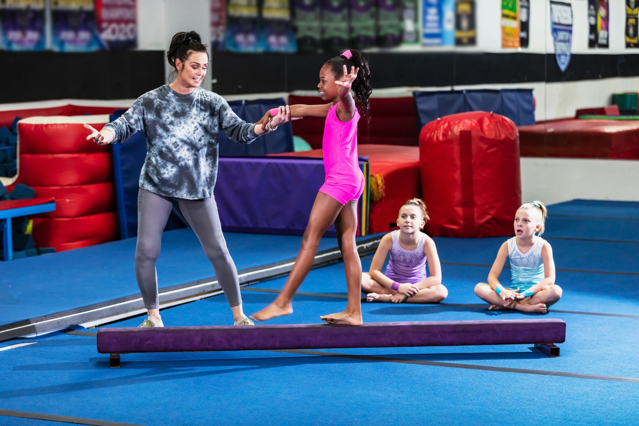 Coach supporting a child during a fitness activity